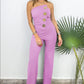 Mouwloze jumpsuit met wijde pijpen en knoopversiering