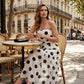 Elegante strapless jurk met stippen en gelaagde rok