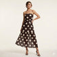Elegante strapless jurk met stippen en gelaagde rok